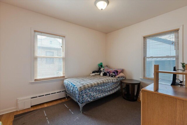 418 Bonnie Brae Ave, Itasca, IL 60143 - bedroom with a baseboard heating unit, wood finished floors, and multiple windows