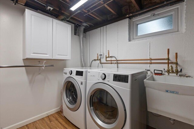 418 Bonnie Brae Ave, Itasca, IL 60143 - washroom featuring light wood-style flooring, a sink, washer and dryer, and cabinet space