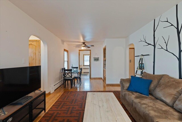 418 Bonnie Brae Ave, Itasca, IL 60143 - living area featuring baseboard heating, a ceiling fan, radiator heating unit, wood finished floors, and arched walkways