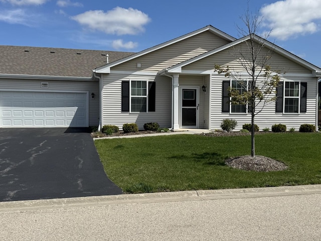 ranch-style house with an attached garage, a front yard, and aphalt driveway