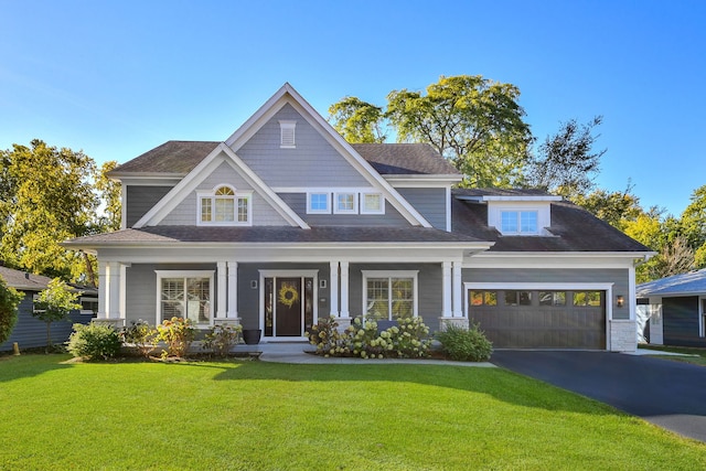 craftsman house featuring aphalt driveway, a front yard, roof with shingles, and a garage