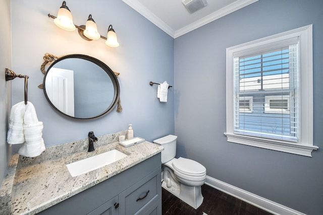 bathroom featuring crown molding, wood finished floors, vanity, baseboards, and visible vents