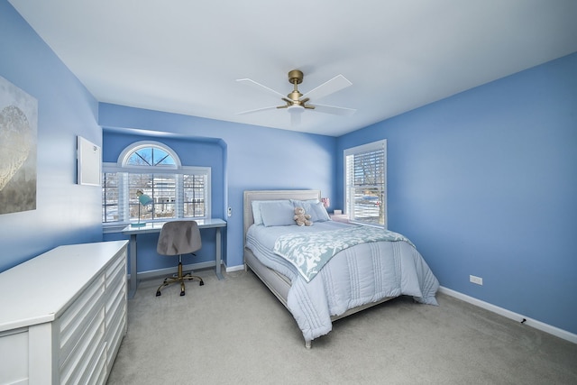 bedroom with ceiling fan, light carpet, and baseboards