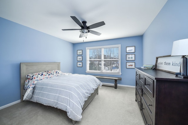 bedroom featuring light colored carpet, ceiling fan, and baseboards