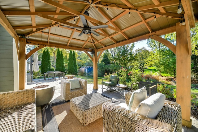 view of patio featuring a gazebo, a ceiling fan, outdoor dining space, and an outdoor living space