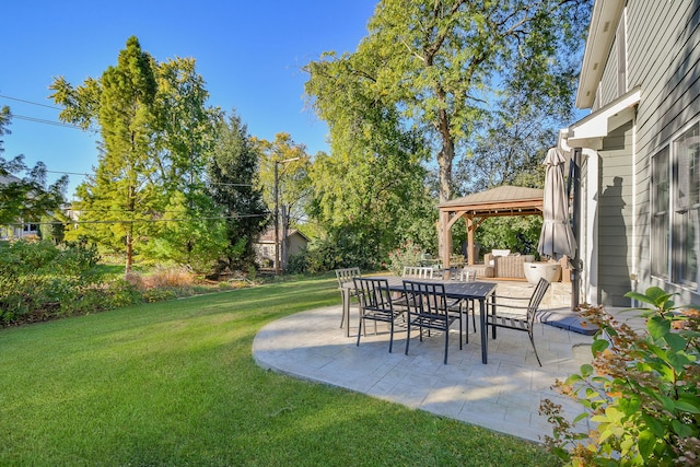 view of yard featuring outdoor dining area, a gazebo, and a patio