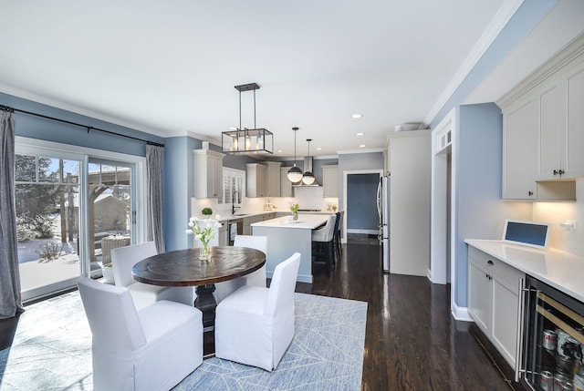 dining space featuring baseboards, ornamental molding, wine cooler, dark wood-style floors, and recessed lighting