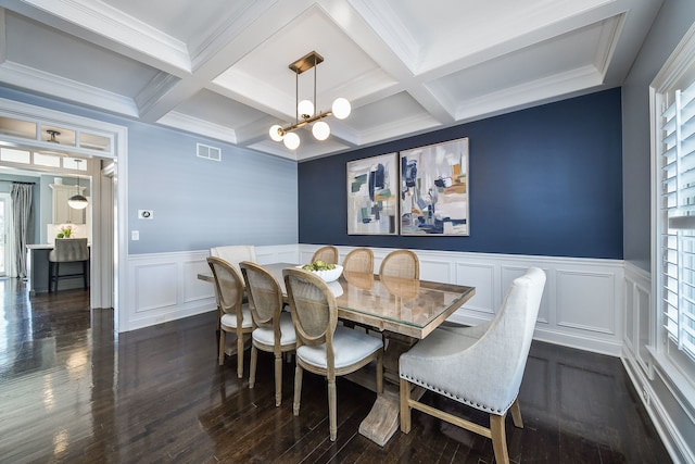 dining space with dark wood-type flooring, visible vents, a wealth of natural light, and beamed ceiling
