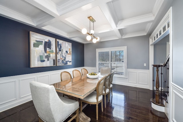 dining space with dark wood finished floors, crown molding, a chandelier, and beamed ceiling