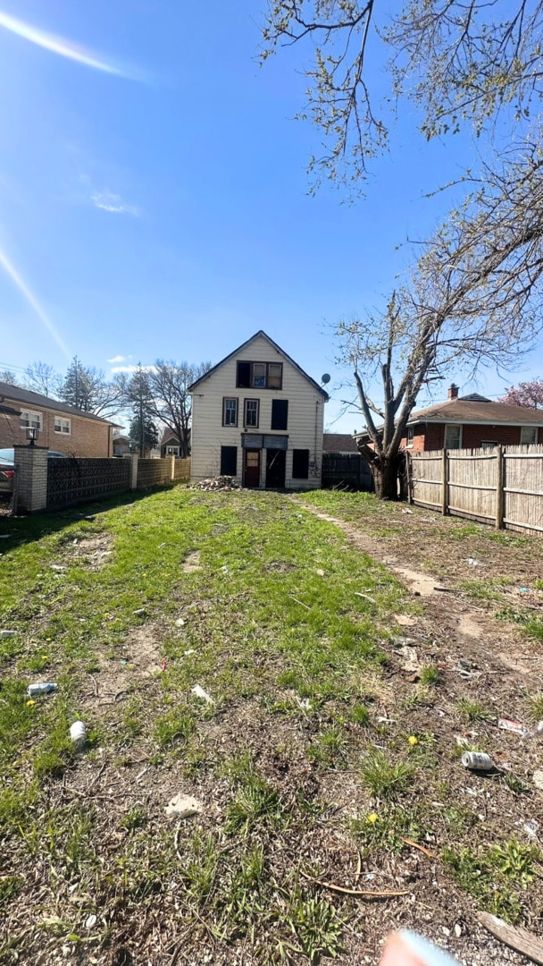 back of property featuring fence
