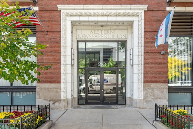 view of exterior entry with french doors and brick siding
