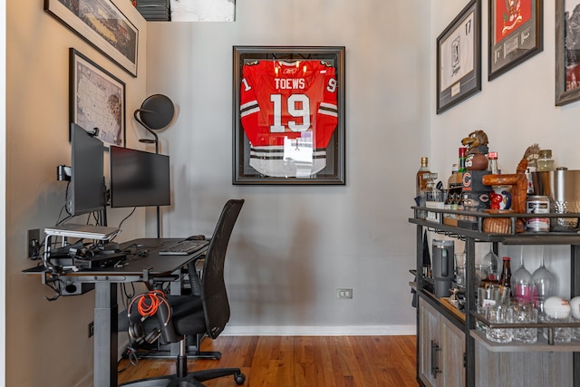 office with wood finished floors and baseboards