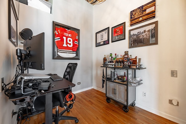 home office featuring wood finished floors and baseboards