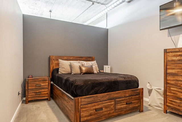 bedroom featuring light carpet and baseboards