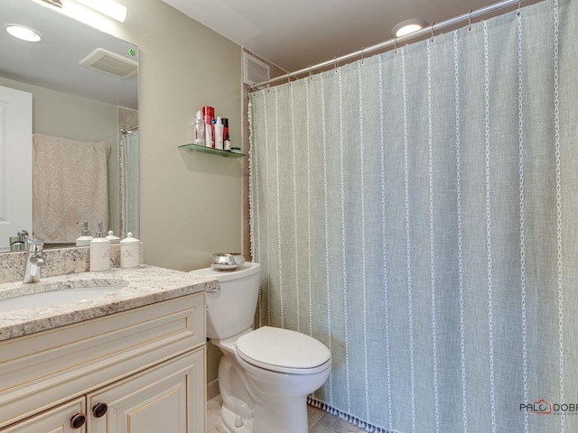 bathroom with toilet, vanity, tile patterned floors, and visible vents