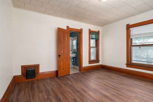 765 N Main St, Pontiac, IL 61764 - spare room with baseboards, visible vents, and dark wood-style flooring