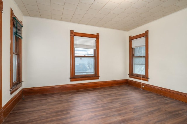 765 N Main St, Pontiac, IL 61764 - spare room featuring a wealth of natural light, dark wood-type flooring, and baseboards