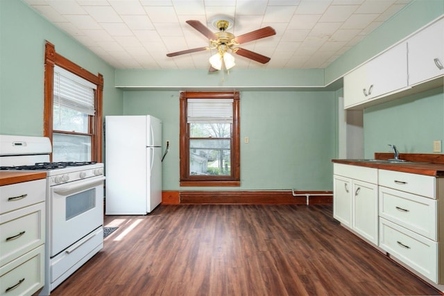 765 N Main St, Pontiac, IL 61764 - kitchen featuring white cabinets, a sink, ceiling fan, dark wood finished floors, and white appliances
