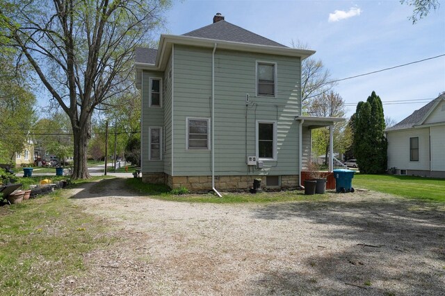 765 N Main St, Pontiac, IL 61764 - rear view of house featuring a chimney