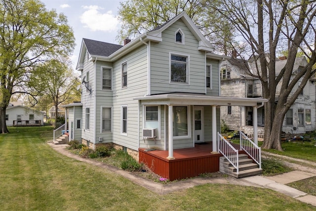 765 N Main St, Pontiac, IL 61764 - victorian house with cooling unit, a front yard, covered porch, and a chimney