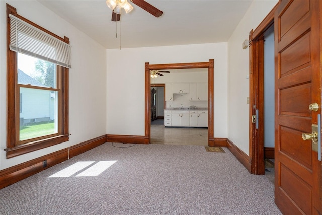 765 N Main St, Pontiac, IL 61764 - carpeted empty room featuring a ceiling fan and baseboards