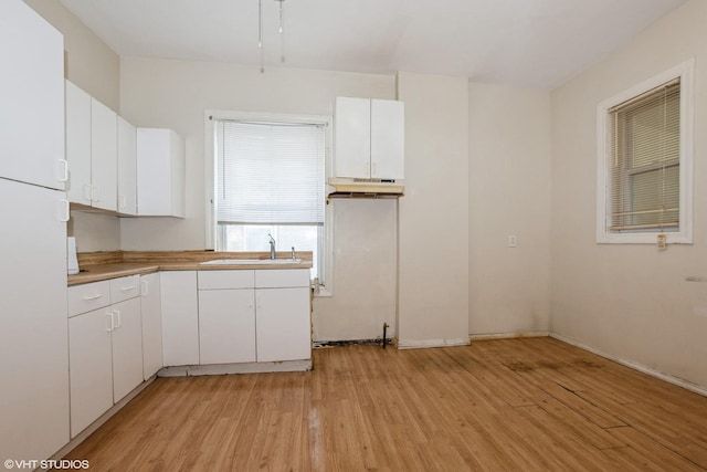 5433 S Carpenter St, Chicago, IL 60609 - kitchen featuring freestanding refrigerator, light wood-style floors, white cabinets, and a sink