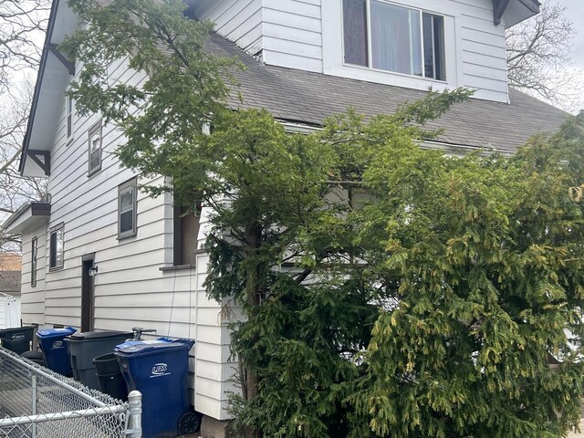 1702 Lincoln St, North Chicago, IL 60064 - view of property exterior with fence and a shingled roof