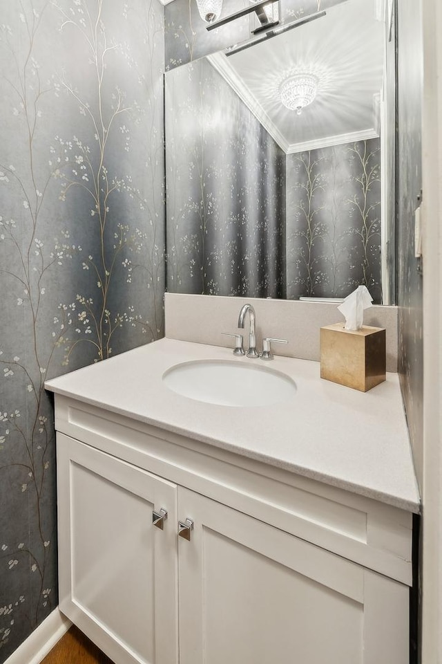 bathroom featuring vanity and wallpapered walls