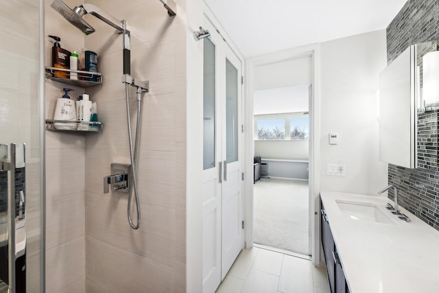 bathroom with backsplash, vanity, tile patterned floors, and a stall shower