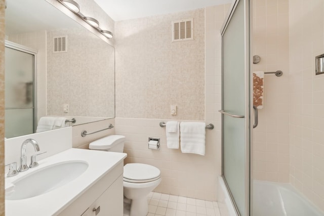 full bath with tile walls, visible vents, tile patterned flooring, and vanity