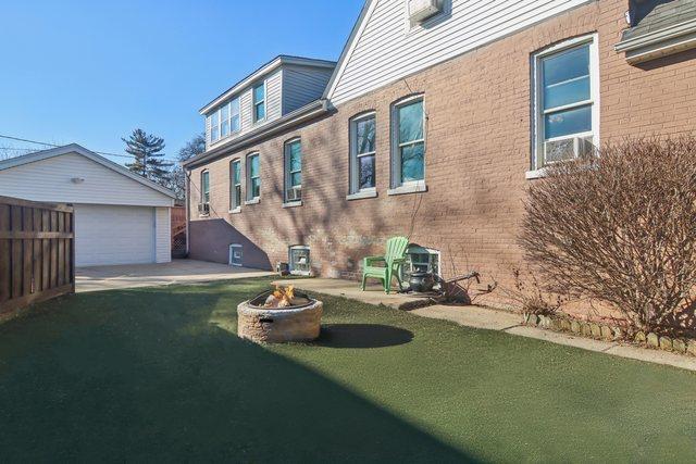 1280 White St, Des Plaines, IL 60018 - exterior space with an outdoor structure, a garage, and an outdoor fire pit