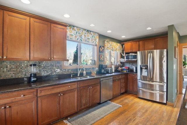 1280 White St, Des Plaines, IL 60018 - kitchen with a sink, appliances with stainless steel finishes, brown cabinets, and light wood-style flooring