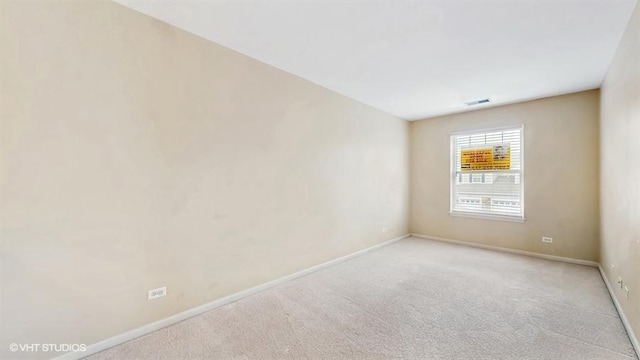 unfurnished room with baseboards, visible vents, and carpet floors