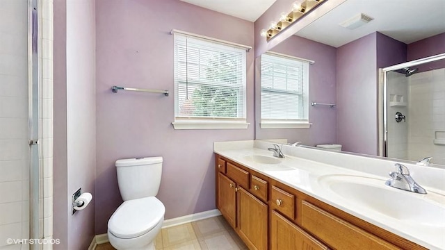 full bath featuring visible vents, a sink, a tile shower, and toilet