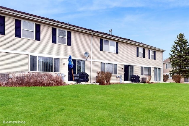 back of house with a yard
