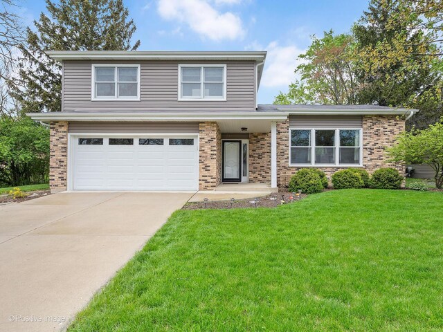 view of front of property featuring brick siding, an attached garage, driveway, and a front lawn