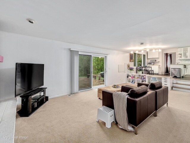 kitchen featuring a toaster, baseboards, white cabinetry, and track lighting