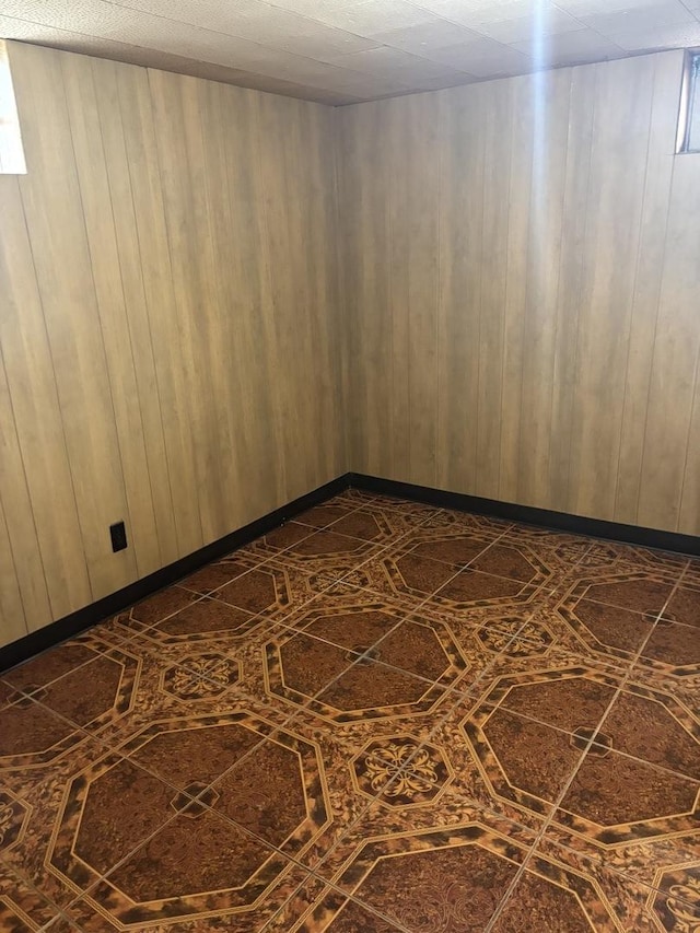 empty room featuring wooden walls