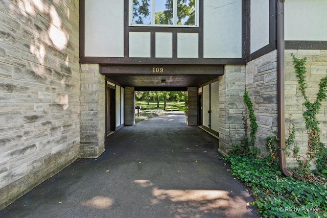 109 3rd Ave, Montgomery, IL 60538 - property entrance featuring stone siding, a carport, and stucco siding