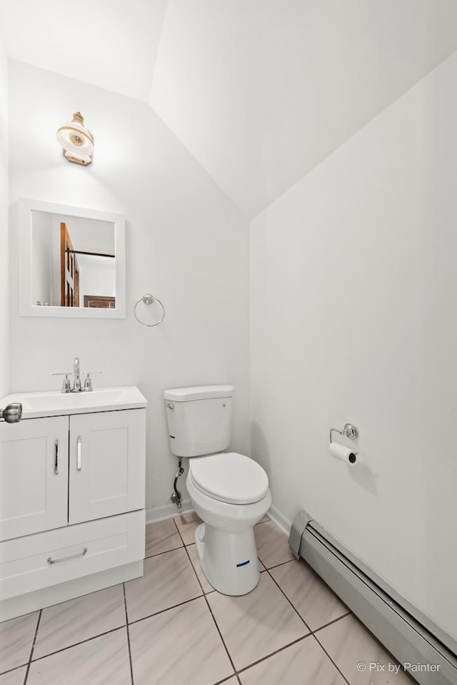 109 3rd Ave, Montgomery, IL 60538 - bathroom featuring a baseboard radiator, vanity, tile patterned flooring, and lofted ceiling