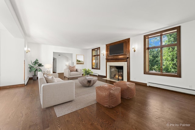 109 3rd Ave, Montgomery, IL 60538 - living room featuring a baseboard heating unit, wood finished floors, and a fireplace