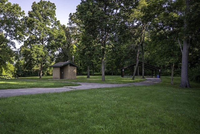 view of home's community featuring a storage shed, an outdoor structure, a gazebo, and a yard