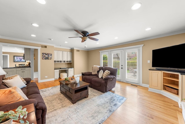 living area featuring ceiling fan, light wood-type flooring, baseboards, ornamental molding, and recessed lighting