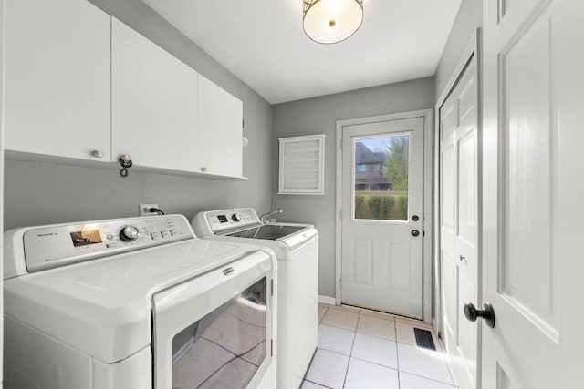 laundry area with cabinet space, baseboards, light tile patterned floors, visible vents, and washing machine and dryer