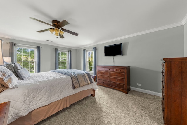 carpeted bedroom featuring crown molding, baseboards, and ceiling fan