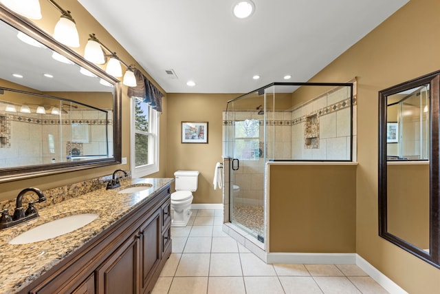 bathroom featuring a sink, baseboards, tile patterned flooring, and visible vents