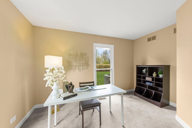 carpeted office with baseboards and visible vents