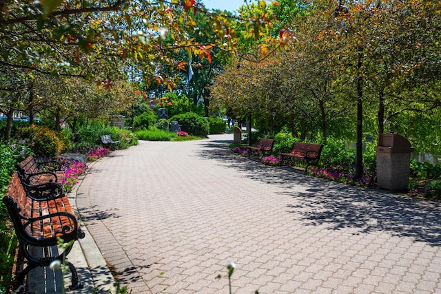 view of property's community featuring decorative driveway