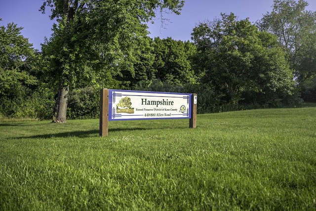 community sign featuring a lawn