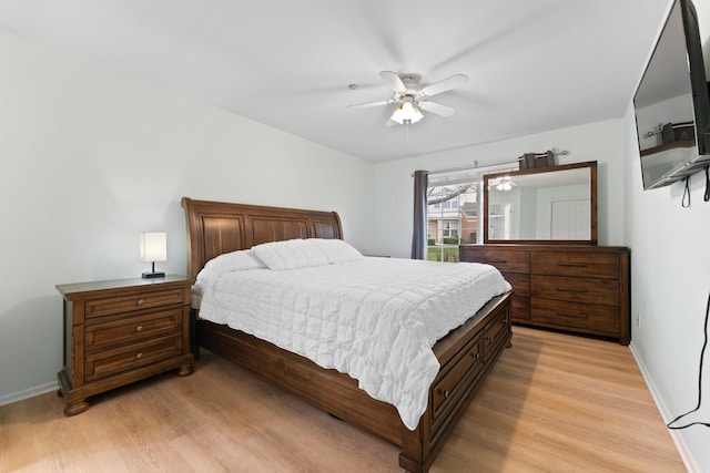 bedroom with baseboards, ceiling fan, and light wood finished floors